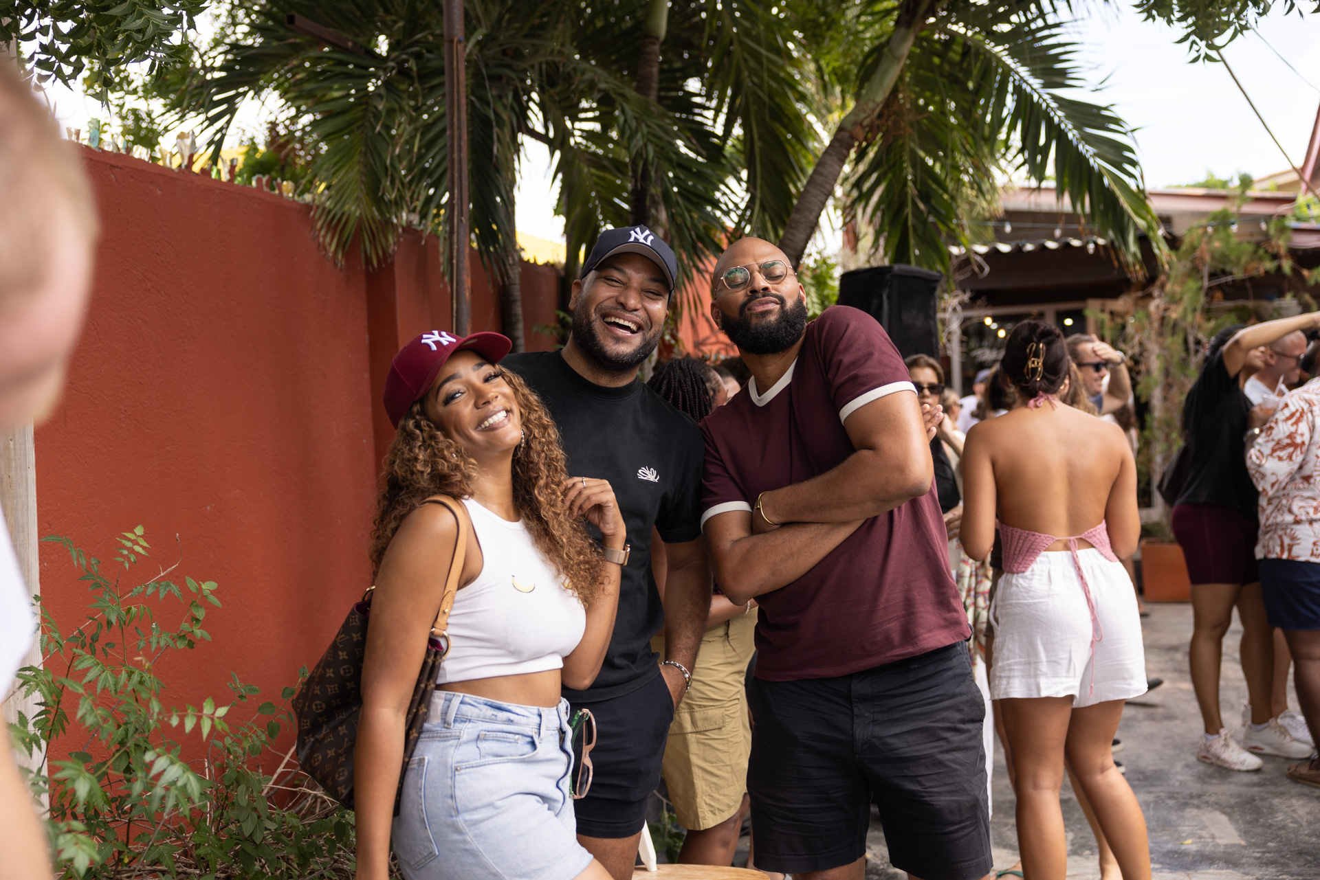 Friends smiling together in the Pakaya Society yard