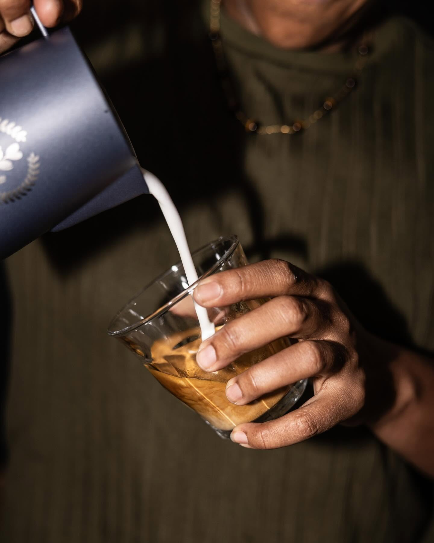 Milk poured into a fresh espresso